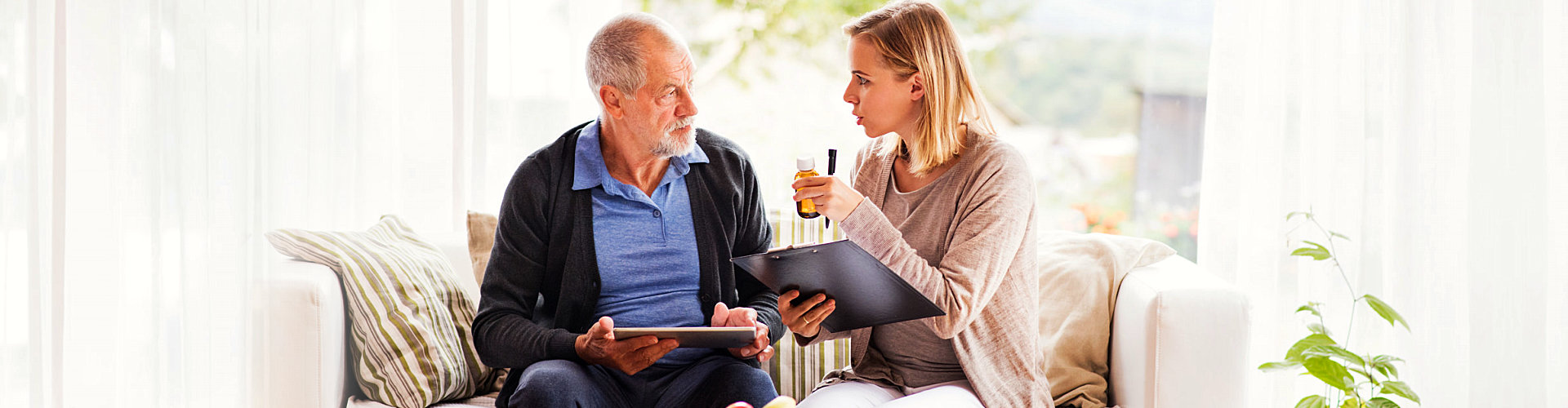 caregiver talking to her senior patient