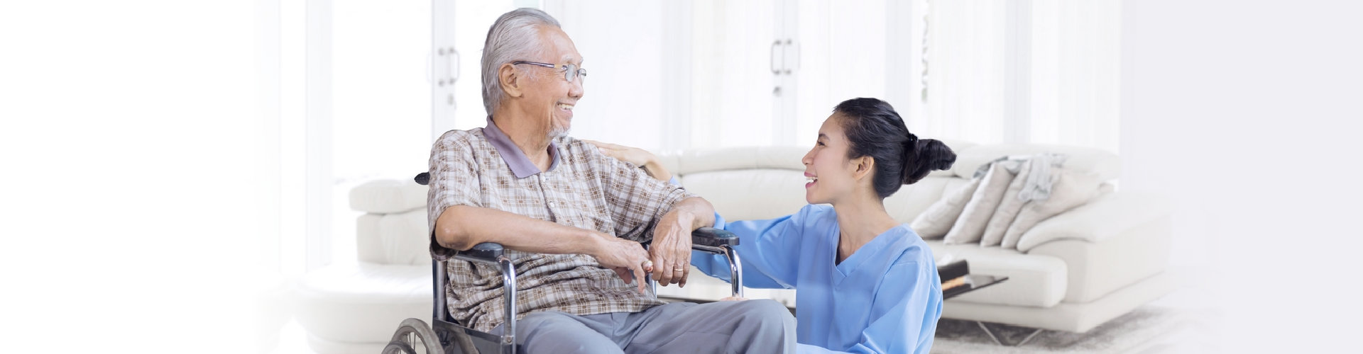 senior man on a wheelchair with his caregiver