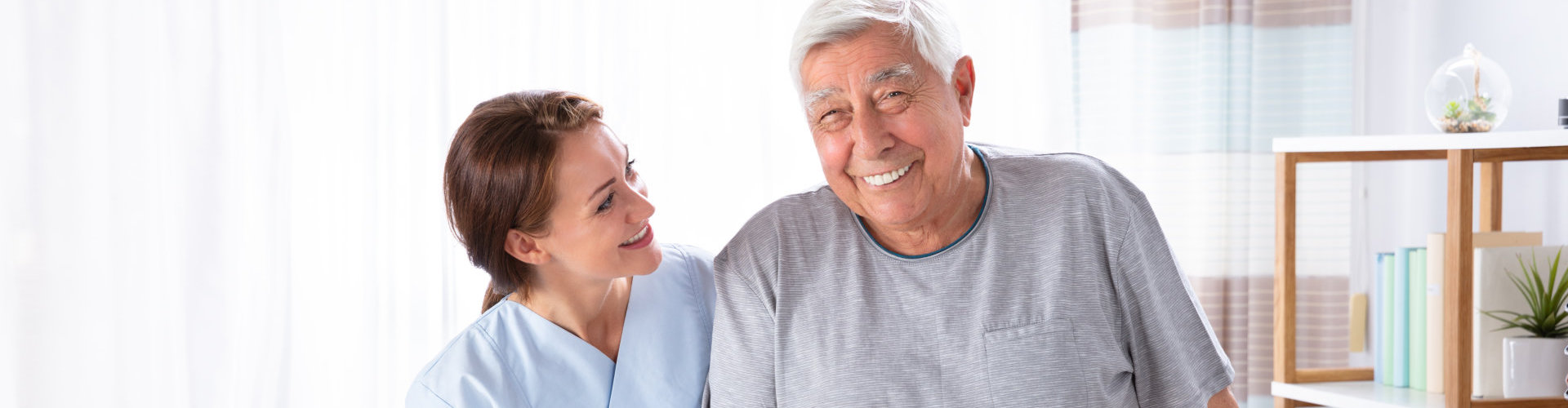 caregiver helping his senior patient walk